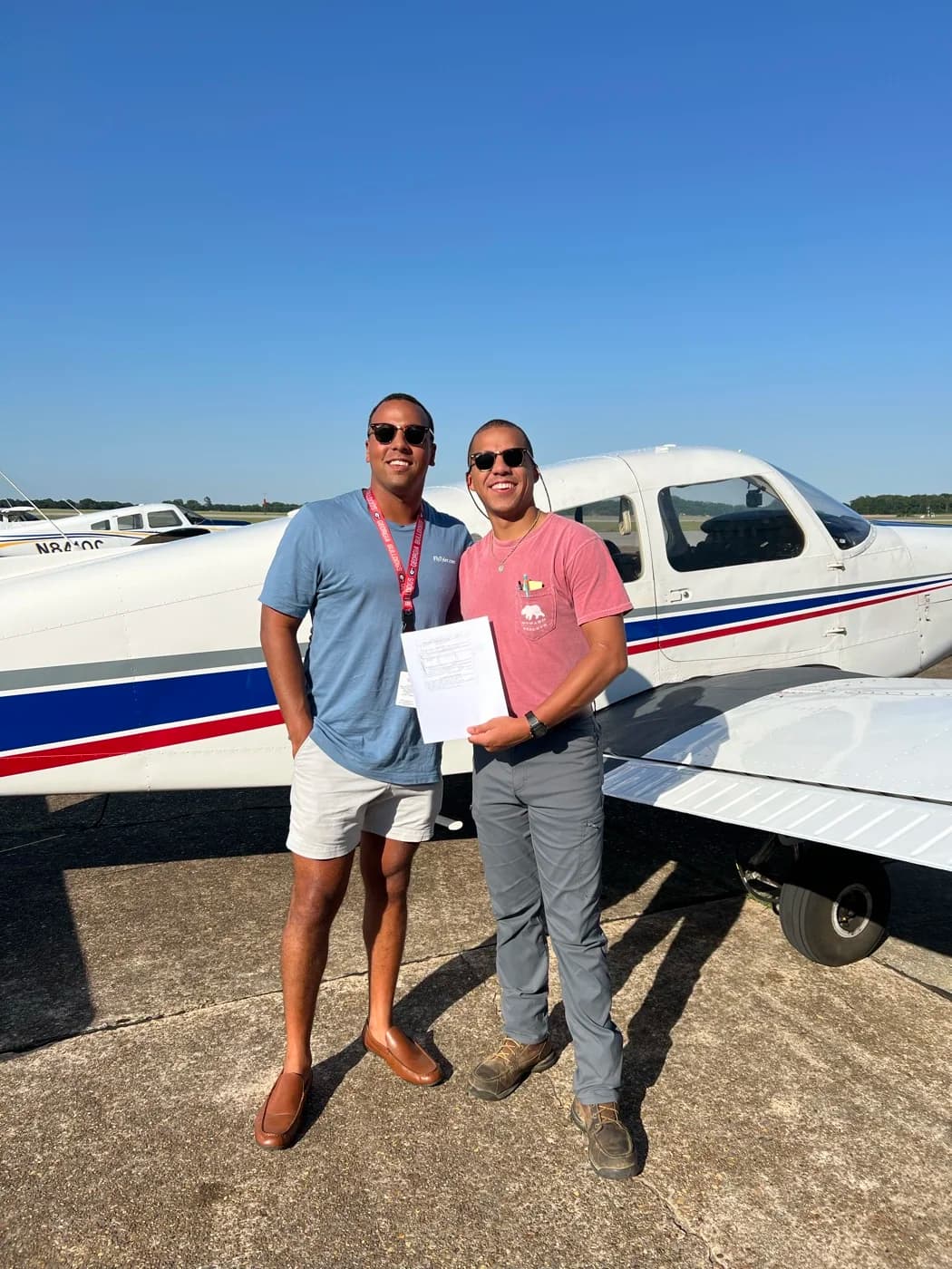 ACOM Aviation checkride moment in front of a Piper Cherokee at Ozark-Blackwell Airport (71J)